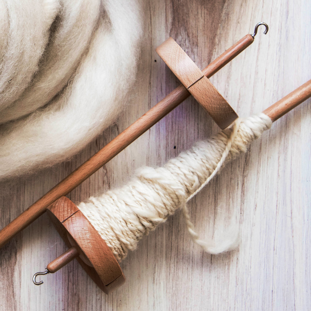 Hand spinning yarn on a drop spindle 