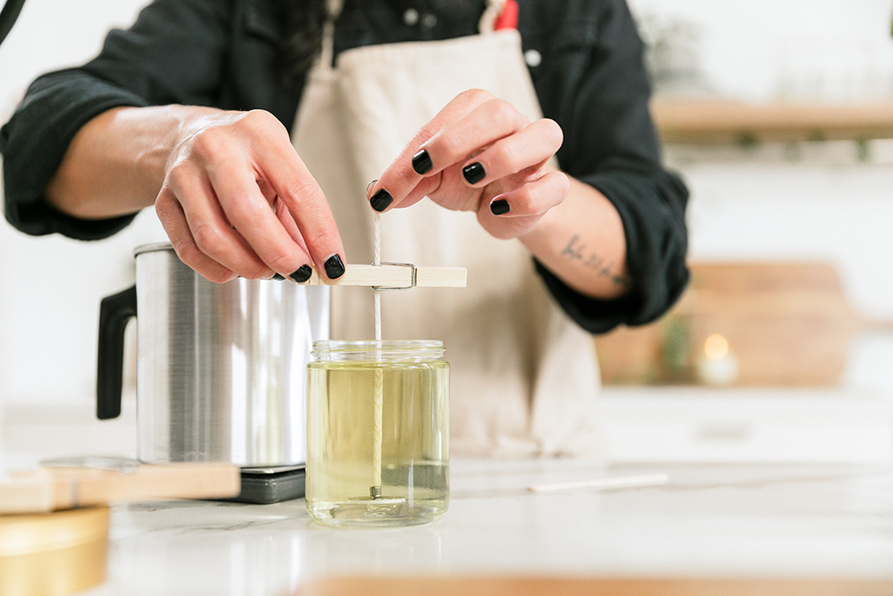 Female Candle Maker Pouring Melted Orange Wax Into The Glass With Glued  Wooden Wick And Measure It On Digital Scale. Wearing Protective Work Wear. Candle  Making Process Stock Photo, Picture and Royalty