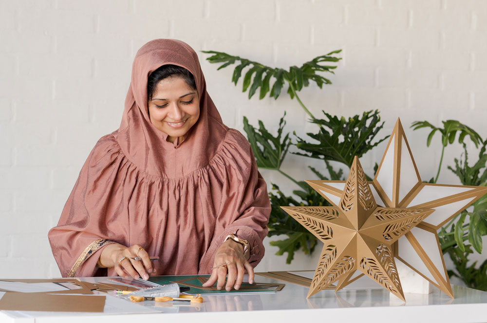 Paper artist Zahra Ammar making paper star lanterns