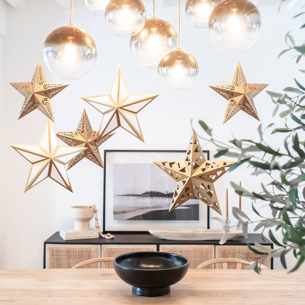 Paper star lanterns hanging over dining room table