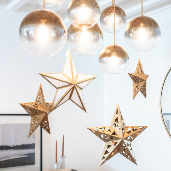 Paper star lanterns hanging over dining room table